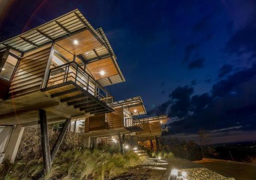 a building with stairs on it at night at Pacific Kalokairi - Adults Only in Tamarindo