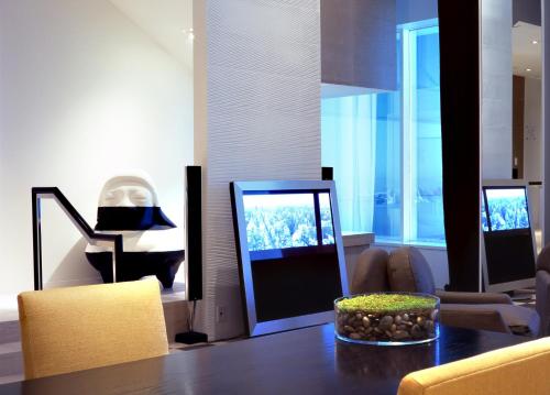 a living room with a table and a television at SKYLOFTS at MGM Grand in Las Vegas