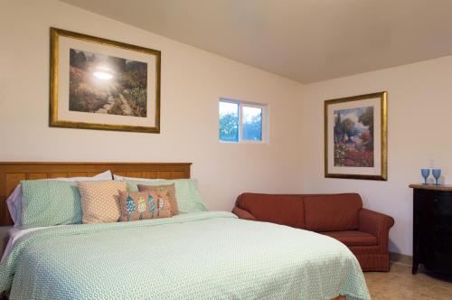 a bedroom with a bed and a chair at Casa Del Sol in Carpinteria