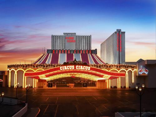 
a large red and white building with a clock on it at Circus Circus Hotel, Casino & Theme Park in Las Vegas
