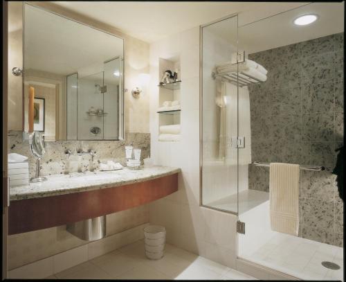 a bathroom with a shower, sink, and tub at Borgata Hotel Casino & Spa in Atlantic City