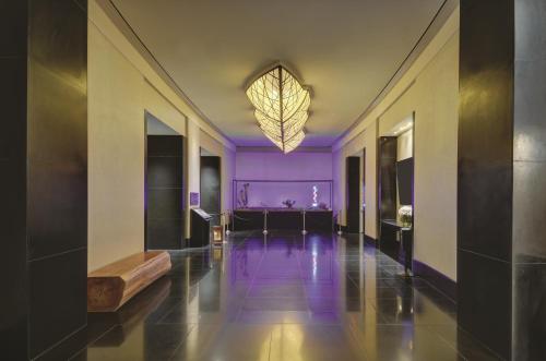 a hallway with purple walls and a large chandelier at Delano Las Vegas at Mandalay Bay in Las Vegas