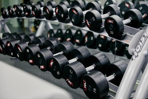 a row of dumbbells on a rack in a gym at Park MGM Las Vegas in Las Vegas