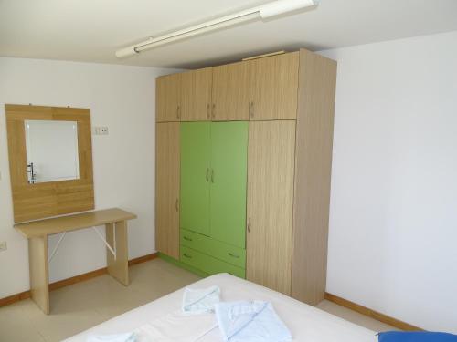 a room with a green cabinet and a mirror at Gaitani Village in Léntas