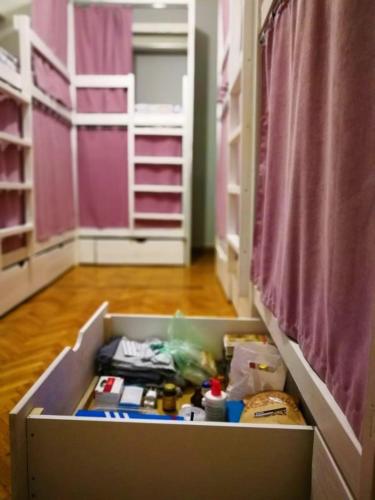 an open drawer in a room with a bedroom at Булгакоff- укриття поряд, 20 метрів in Kyiv