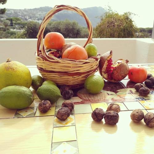 a basket of fruit and nuts on a table at Residence Limoneto Ischia in Ischia
