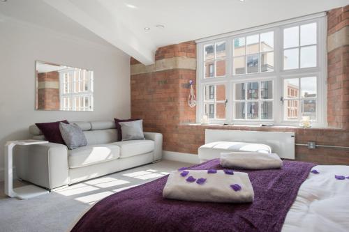 a living room with a bed and a couch at ChocoLets - The Quality Suite in York