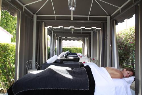 a man laying on a bed under a canopy at Avalon Hotel & Bungalows Palm Springs, a Member of Design Hotels in Palm Springs