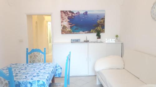 a white room with a bed and a couch at Penisola Apartment in Vico Equense