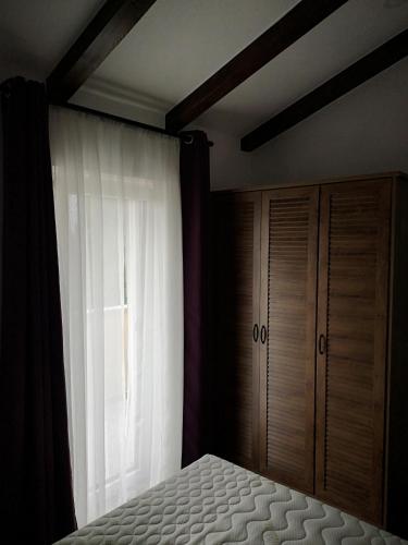 a bedroom with a bed and a window at Apartments Gea in Lucija