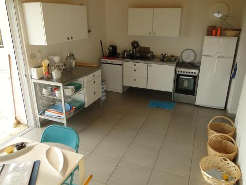 a kitchen with white cabinets and a white floor at Six-bedroom House With Terrace Ionian Sea View in Neokhórion