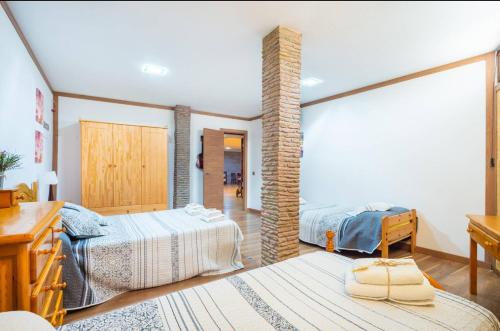 a bedroom with two beds and a desk with a desk at Casa Roque Aguayro in Agüimes