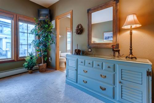 a blue dresser in a bathroom with a mirror at One-Bedroom Elk Run Condo 23 in Copper Mountain