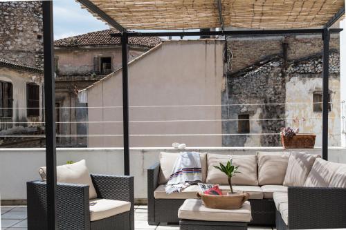 a patio with a couch and chairs on a balcony at Concierge Monastiraki in Athens
