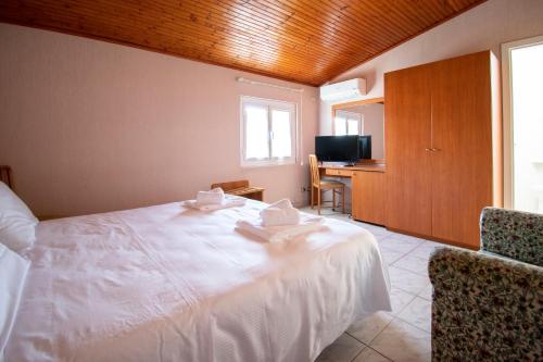 a bedroom with a large white bed and a desk at Hotel Villa Giada in Marina di Massa