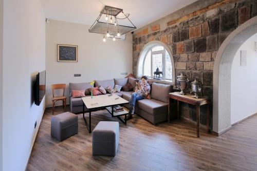 two children sitting on a couch in a living room at Highland Hostel in Yerevan