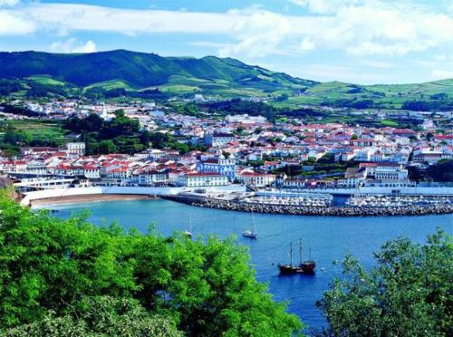 a city with a harbor with boats in the water at Casa de Hospedes Isaias in Angra do Heroísmo