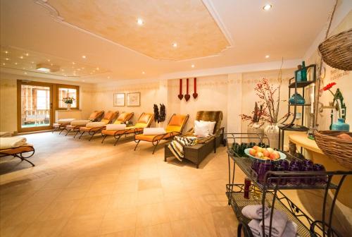 a large living room with couches and chairs at Almhof Roswitha in Hippach