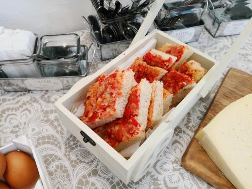 a white box filled with sandwiches and eggs on a table at Hotel Villa Giada in Marina di Massa