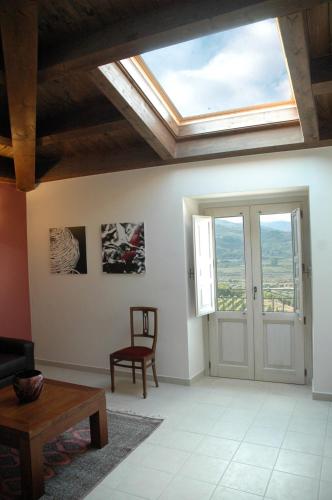a living room with a skylight on the ceiling at Feudo Vagliasindi -Wine Experience- in Randazzo