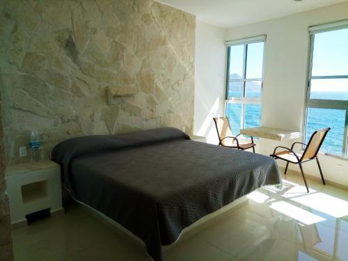 Ένα ή περισσότερα κρεβάτια σε δωμάτιο στο Hotelito Escondido
