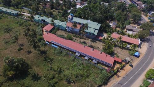 an overhead view of a train in front of a house at The Long Hostel in Arugam Bay