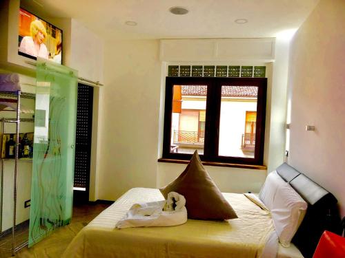 a bedroom with a bed with a baby on it at B&B WELLNESS Junior Suite CAREN in Grinzane Cavour