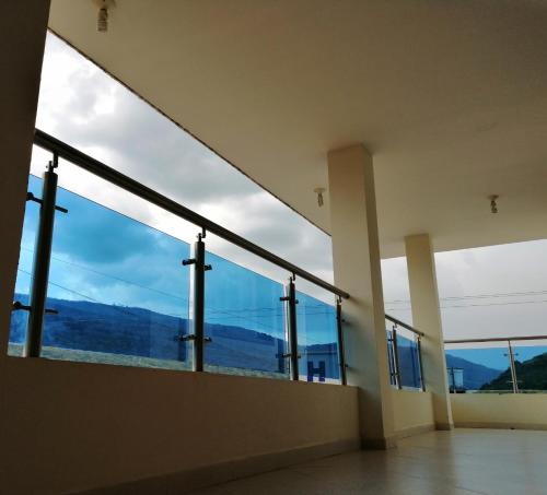 a room with large windows with a view of the mountains at Hotel el Paraíso del Valle in Valle de San José