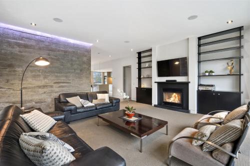 a living room with two couches and a fireplace at City Sanctuary on Kilmore in Christchurch