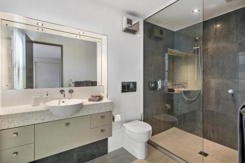 a bathroom with a toilet and a sink and a shower at City Sanctuary on Kilmore in Christchurch