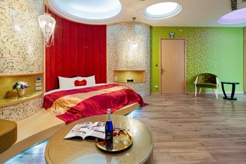 a bedroom with a red bed and a table with a table at Affair motel Co.Ltd in Wuqi