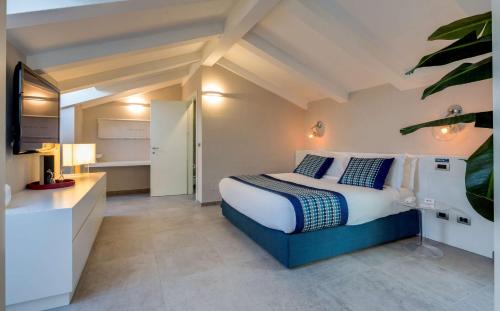 a bedroom with a king sized bed and a television at Best Western Plus Royal Superga Hotel in Cuneo