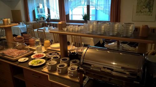 a table with plates and bowls of food on it at Hotel Gesser in Sillian