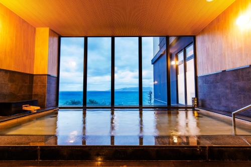 an empty room with a view of the ocean at Umino Ryotei Okinawa Nakamasou in Onna