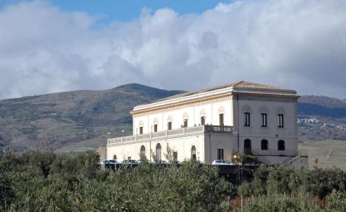 a large white building on top of a hill at Feudo Vagliasindi -Wine Experience- in Randazzo
