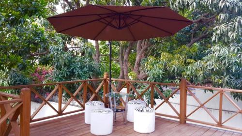 a white umbrella sitting on top of a wooden table at G y V Hotels in Tegucigalpa