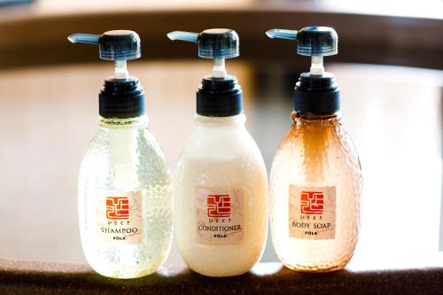 a group of three bottles of detergent sitting next to each other at Umino Ryotei Okinawa Nakamasou in Onna