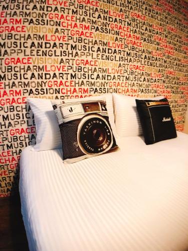 a camera sitting on top of a bed at Traveler Station R15 in Kaohsiung