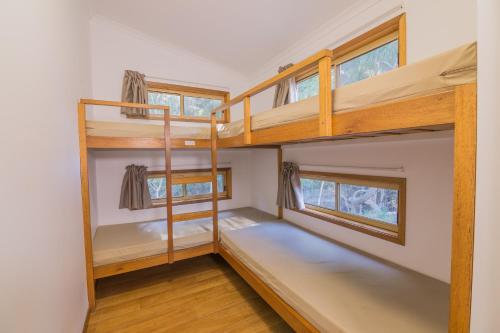 a bedroom with bunk beds in a tiny house at Blue Dolphin Holiday Resort in Yamba