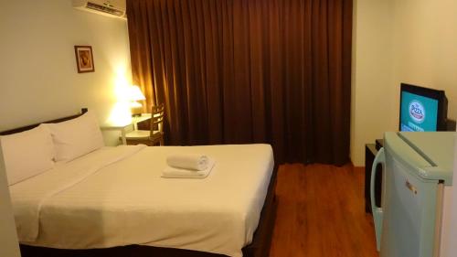 Ένα ή περισσότερα κρεβάτια σε δωμάτιο στο Mango Bedroom Inn