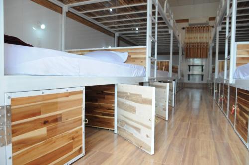 a row of bunk beds in a room at Hoang Nga Garden Guesthouse in Mui Ne