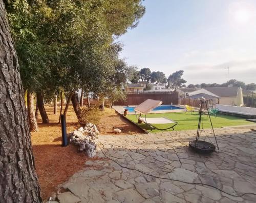 a park with a playground with a swing at Casa Martí in El Vendrell