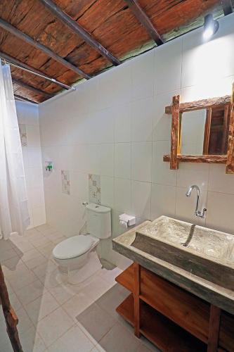 a bathroom with a toilet and a sink at Salim Beach Resort in Gili Islands