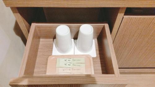 a wooden box with two rolls of paper in it at Sakura Terrace in Kyoto