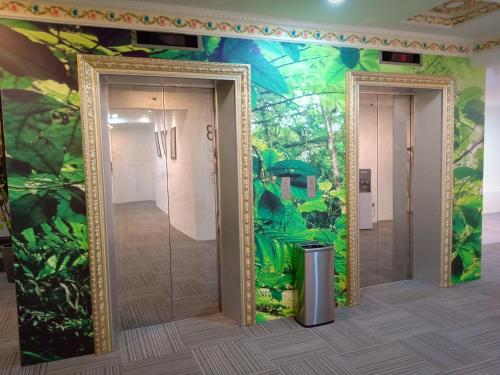 a bathroom with a jungle mural on the wall at H Boutique Hotel Xplorer Loke Yew in Kuala Lumpur