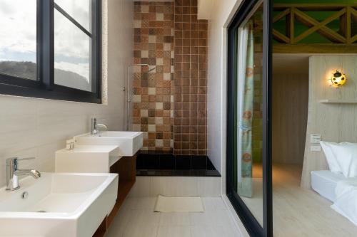 a bathroom with two sinks and a shower at 墾丁宜庭海景親子民宿 in Checheng