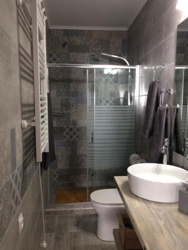 a bathroom with a shower and a toilet and a sink at Ideally Situated Corfu Old Town Apartment in Corfu