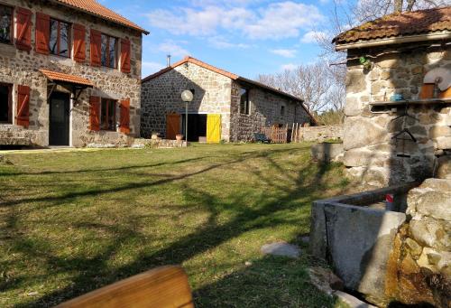 a house with a yard with a bench in front of it at Les Fayettes in Montregard