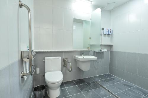 a bathroom with a toilet and a sink at Gwangju Tourist Hotel in Gwangju