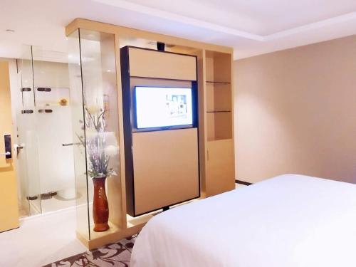 Katil atau katil-katil dalam bilik di Lavande Hotel Taixing Jiangping Road
